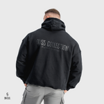 Person wearing a black hoody with 'OVSD Collection' text on the back against a white background