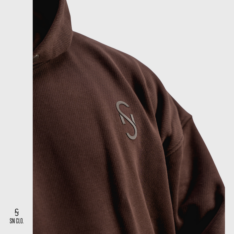 Brown hoody with an SN Clo. logo on a light grey background