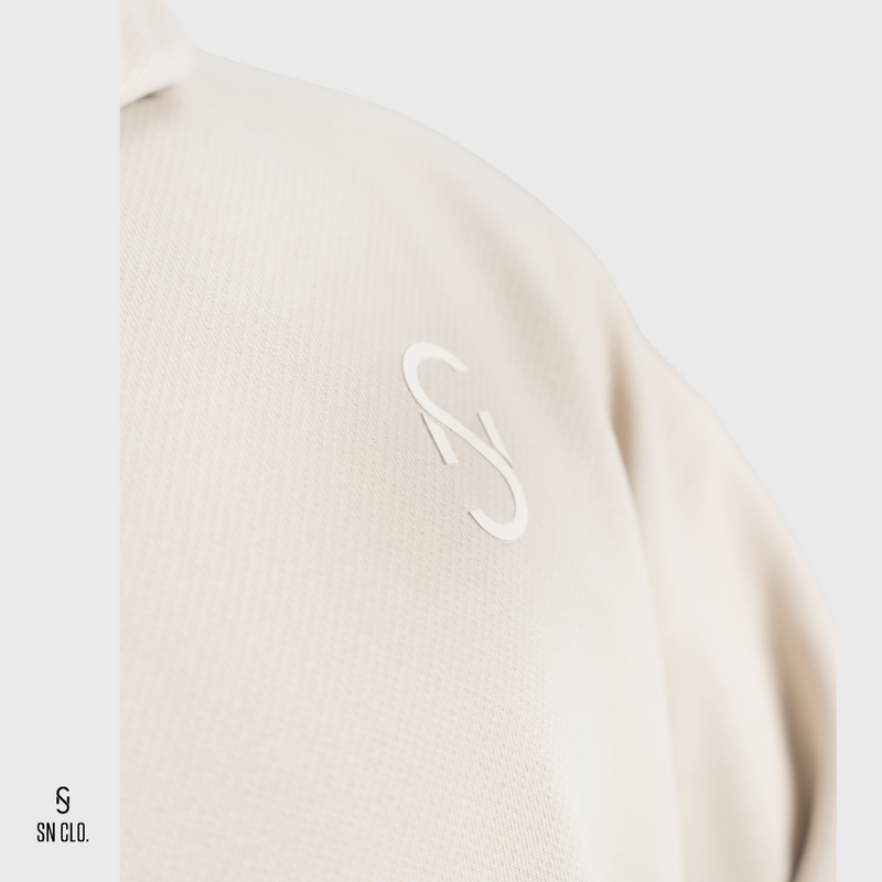 Beige hoodie with a white SN Clo. logo on a light grey background