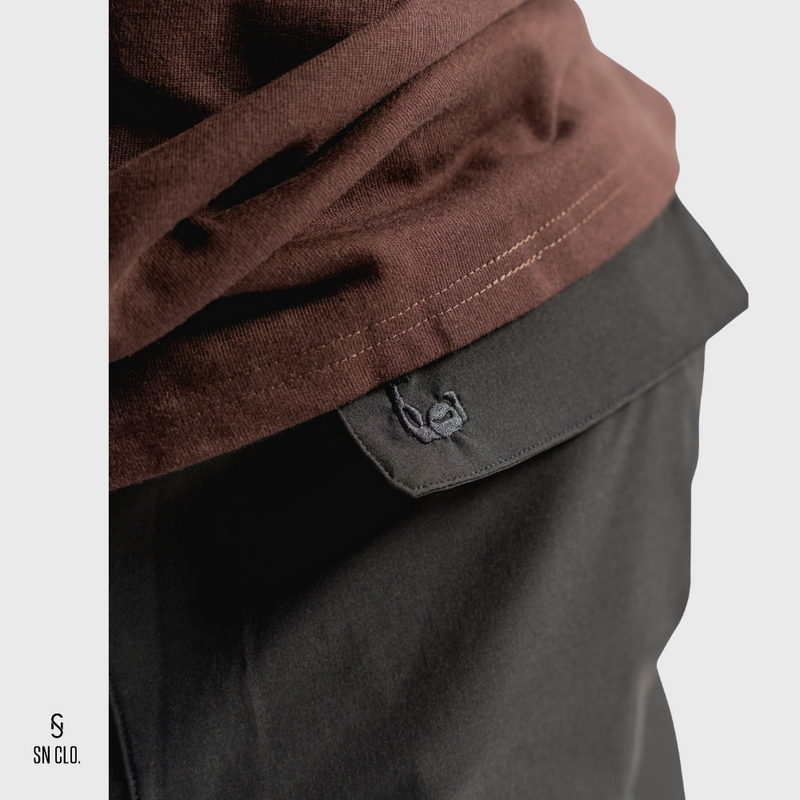 Black SN Clo. cargo shorts reverse pocket that contains embroidered bicep logo  