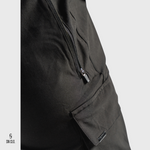 Close-up of SN Clo. black cargo shorts with a zipper on a light grey background