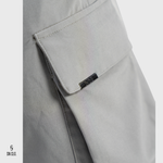 grey SN Clo. cargo shorts with a visible brand label on pocket on a light grey background