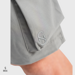 Grey SN Clo. cargo shorts with a visible brand label on a light grey background