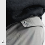 Grey SN Clo. cargo shorts reverse pocket that contains embroidered bicep logo  