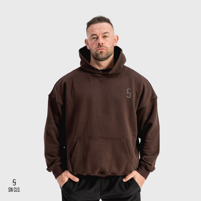 Man wearing a brown hoody with an SN Clo logo on a grey background